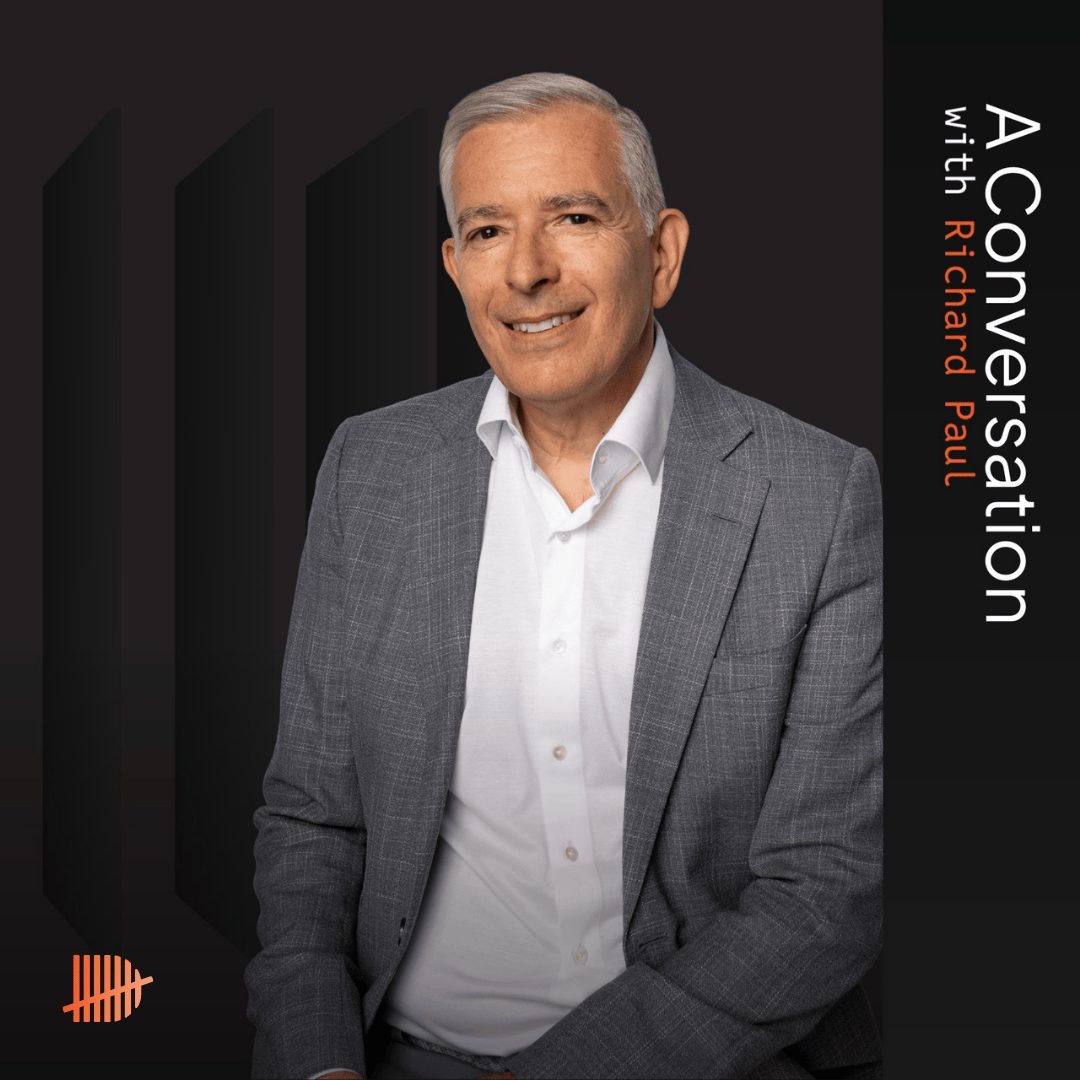 A picture of Richard Paul in front of a black background with the text stating 'In conversation with'.