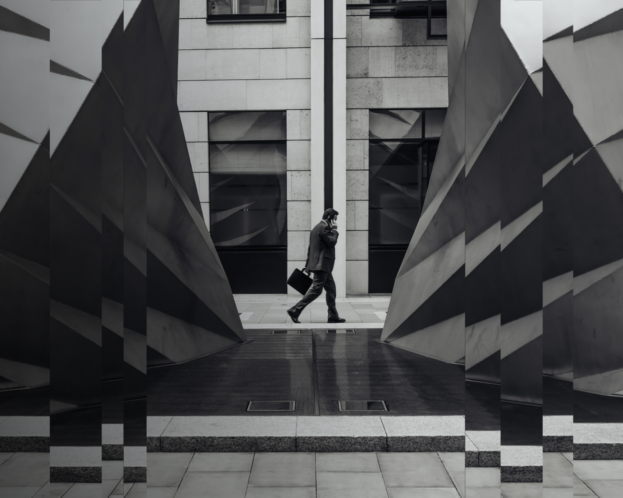 A black and white image of an advisor walking to a meeting.